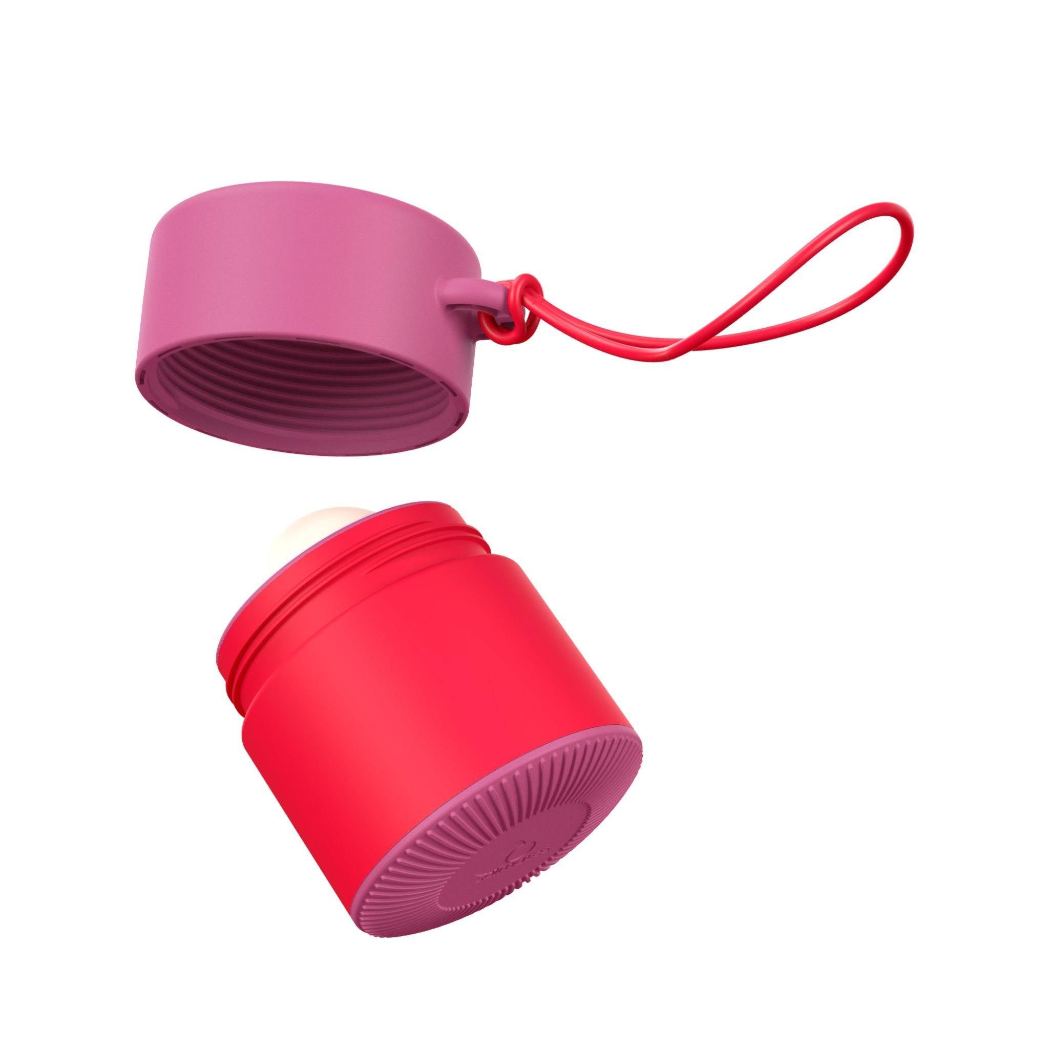 Pink and red refillable roll-on travel applicator with lid off and above body