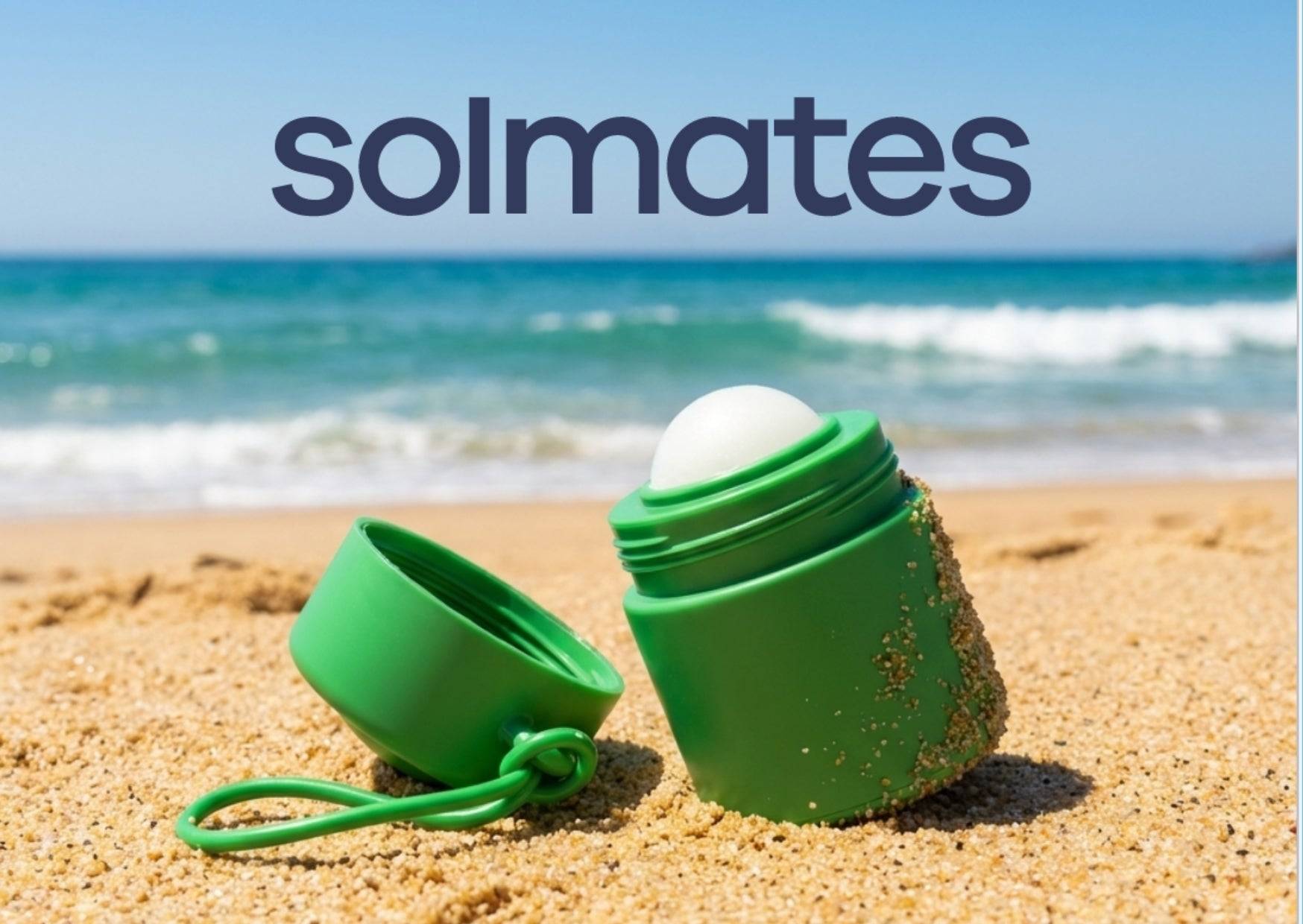 green refillable roll-on applicator with lid to the side sitting in the sand with the ocean in the background and the solmates logo above