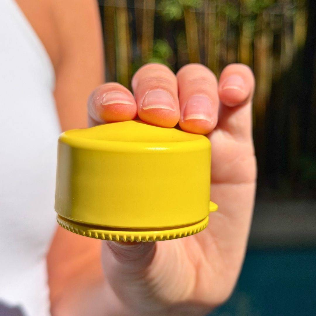 Yellow travel refillable pot held in hands